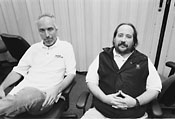 two middle aged men sitting